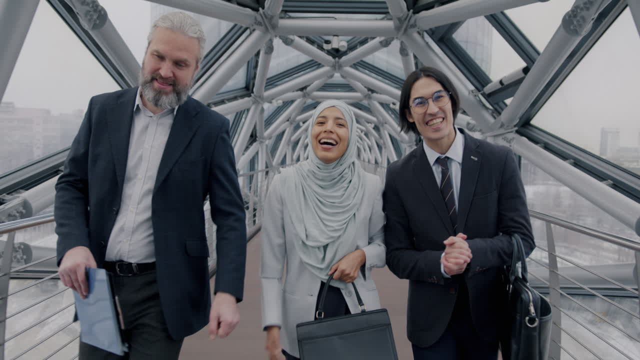 Business Professionals Walking and Discussing in a Modern Bridge