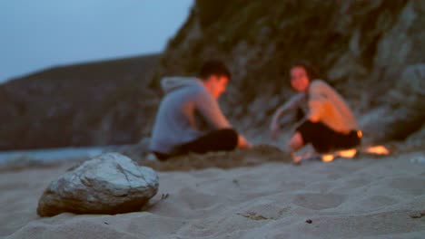 Sentado-alrededor-de-la-playa-de-fuego