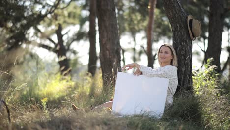 an artist in nature stands before a blank canvas ready to unleash their creativity - an artist, inspired by natures beauty, immerses in a serene scene ready to paint on a blank canvas