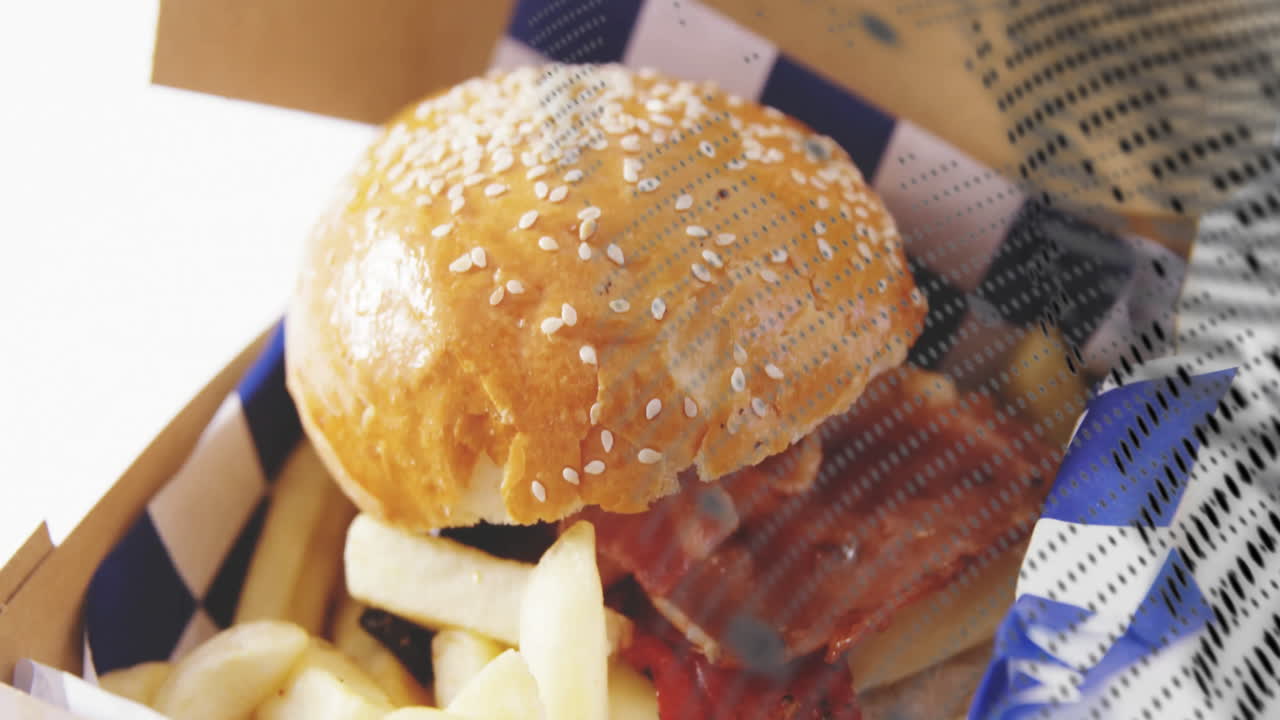 Animation of burger and fries in takeaway box with abstract pattern overlay
