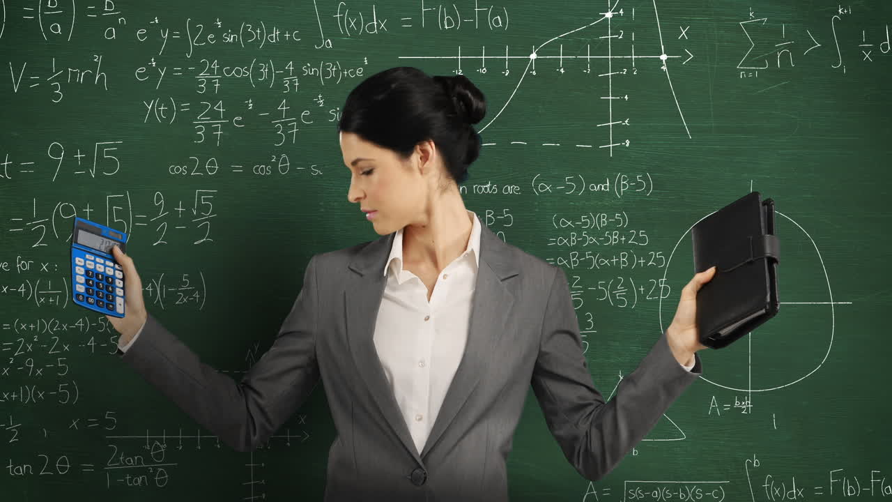 Woman holding calculator and notebook standing and looking around in front of chalkboard