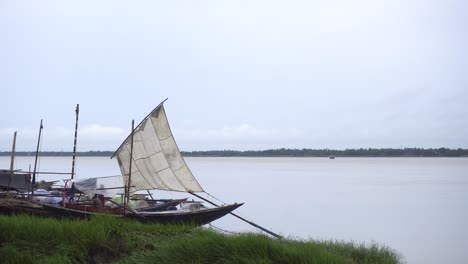 a sailing boats stood on bank of river ganges in india