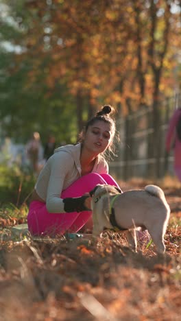 woman enjoying fall afternoon with her pug