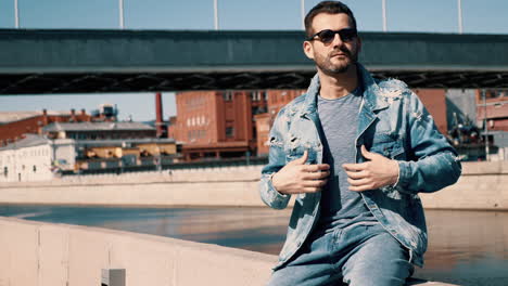 man in denim jacket by the canal