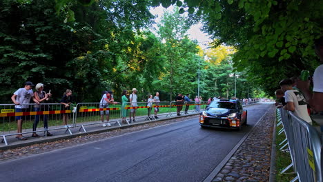 slow motion shot of world rally championship in latvia is attracting excited fans during evening.