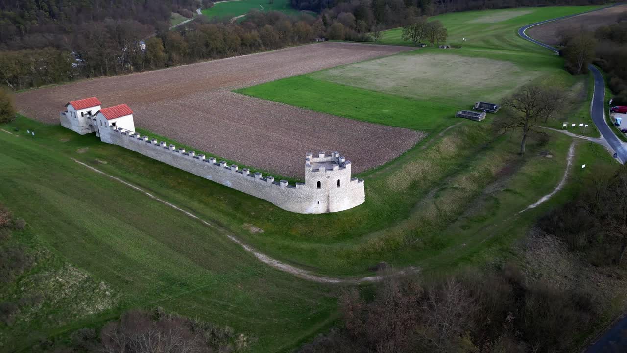 Drone flying around ruins of roman camp during daytime