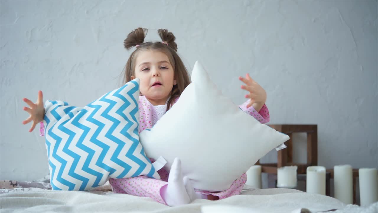 Playful Child in Pajamas with Pillows