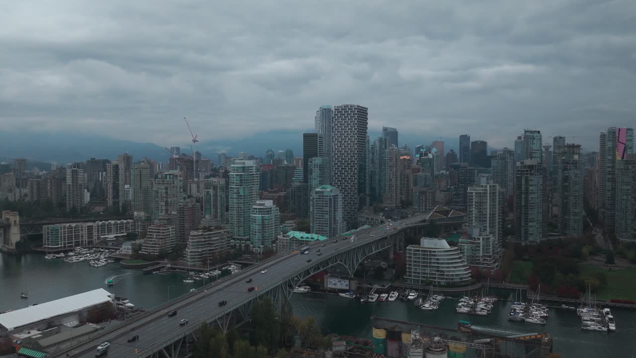 Descending and panning aerial shot of Granville Bridge in downtown Vancouver on a rainy morning in British Columbia, Canada. 4K