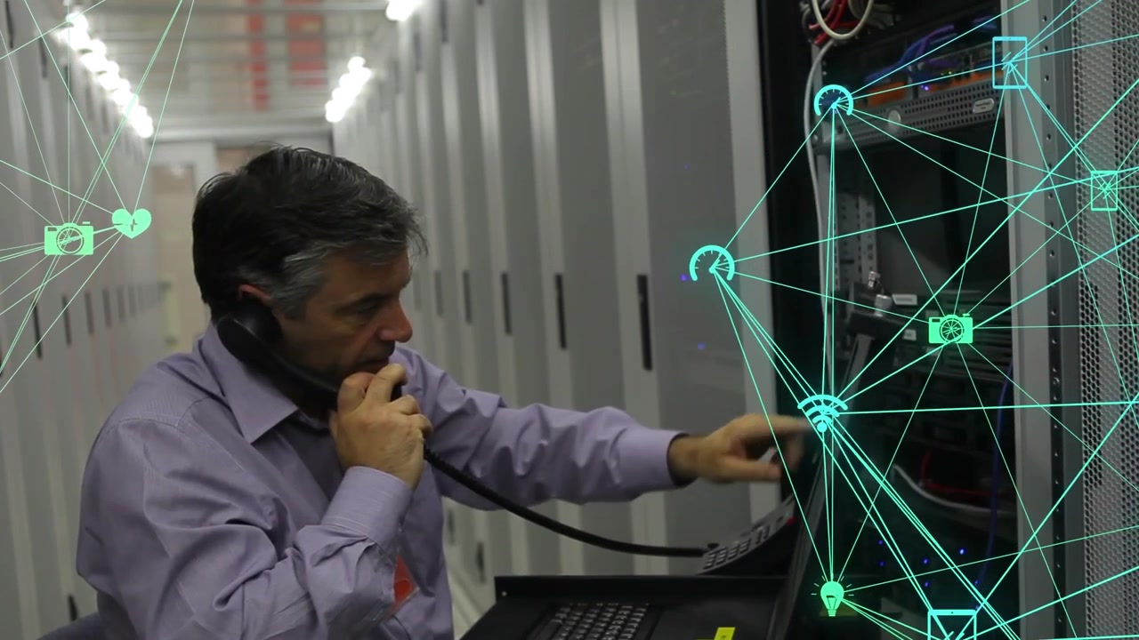 Animation of network of media icons over male technician using phone working in server room
