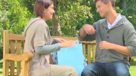 young couple on a bench having done their shopping