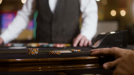 man looking at his hand of cards.