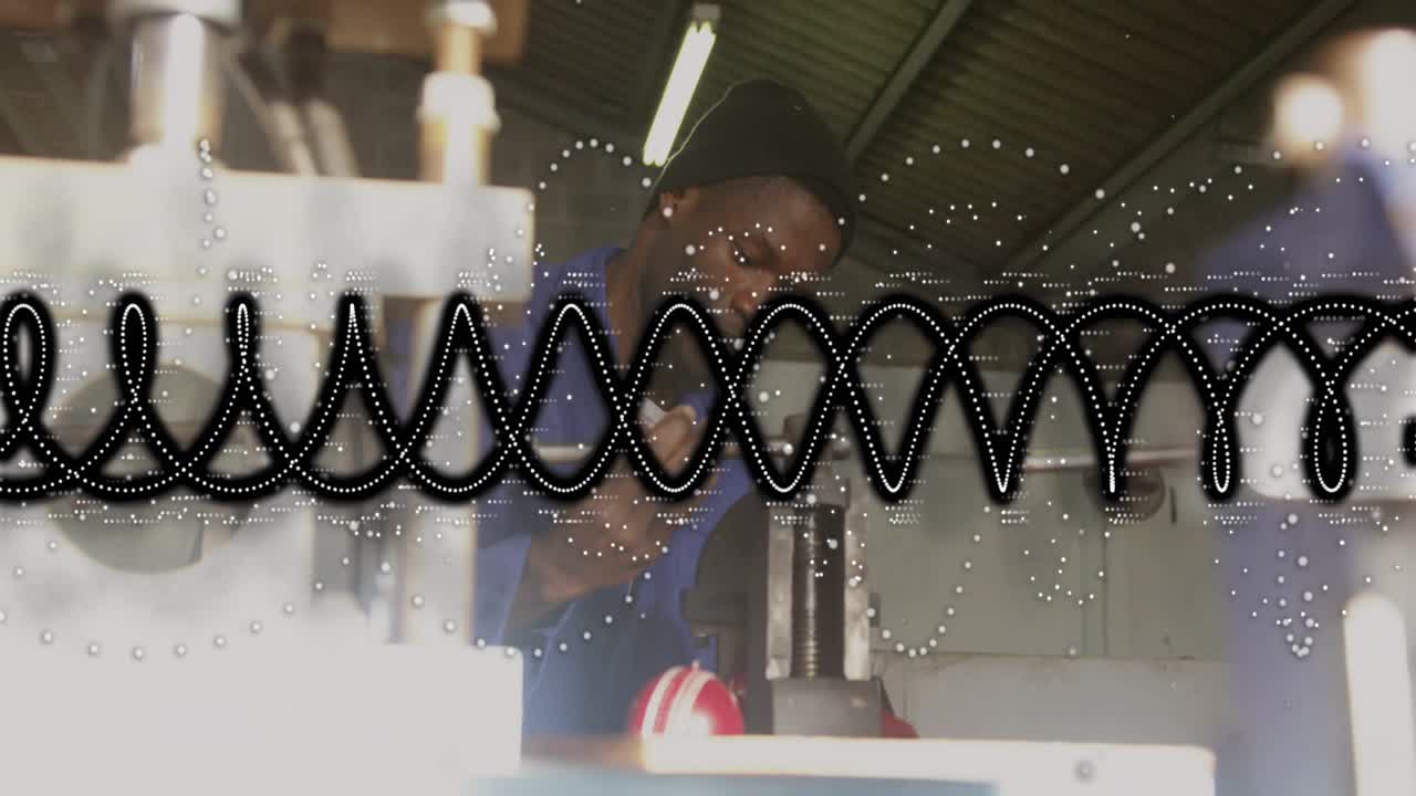 Worker noticing machine needing adjustment, leaning right and adjusting spindle near red knob