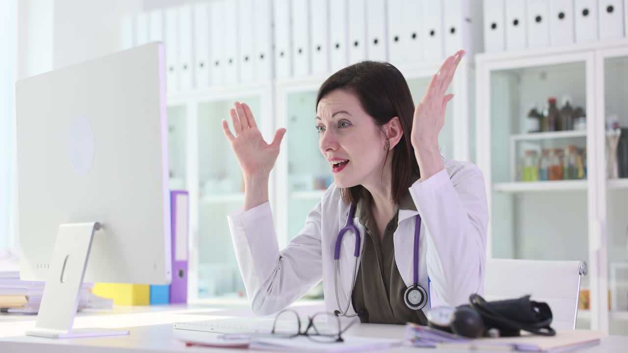 Doctor reacts with surprise or frustration while looking at a computer screen in an office setting