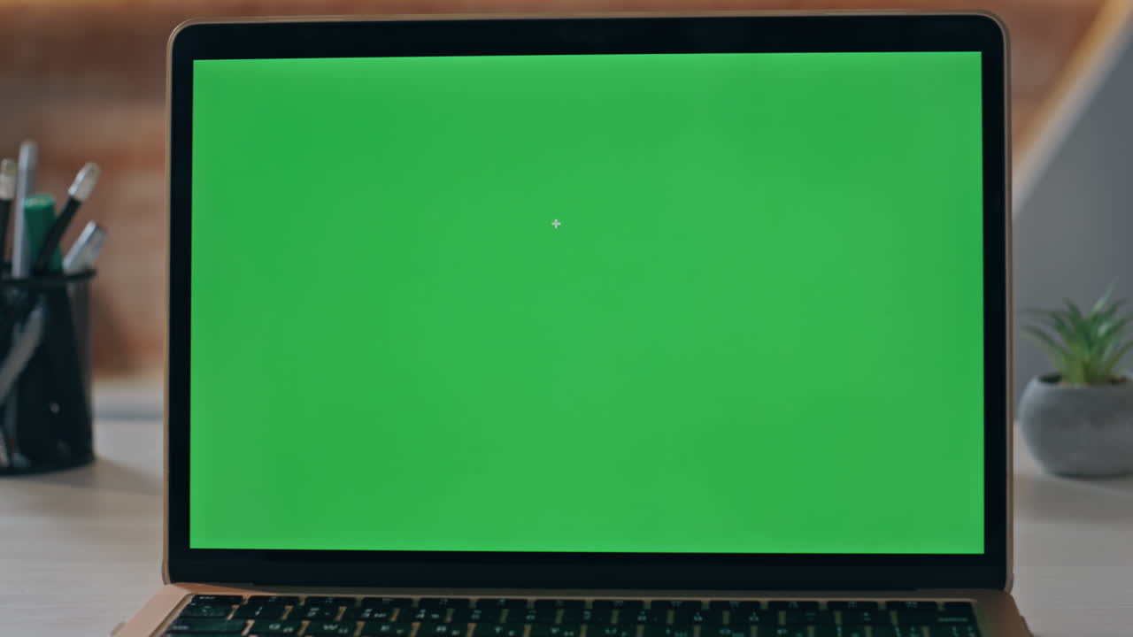 Modern green screen laptop placed on empty office table closeup. Mockup computer