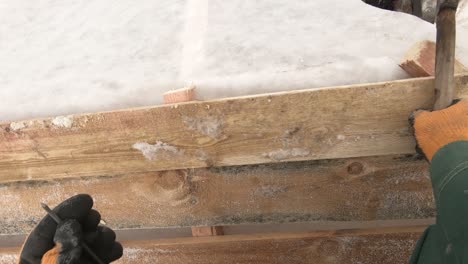 repairing wooden pallet in winter