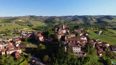 drone orbits historic neive, capturing terracotta roofs and ancient architecture of this langhe wine region village as evening approaches, piedmont, italy. [19]