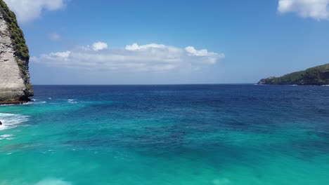 Drone-aerial-footage-over-clear-blue-and-turquoise-sea-water-in-Indonesia