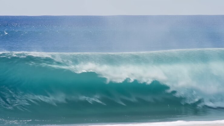 Powerful Turquoise Ocean Wave Breaking on a Sandy Beach
