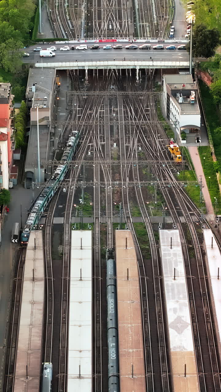 Aerial drone view of a train entering the Milano Cadorna Railway Station, Italy. Vertical