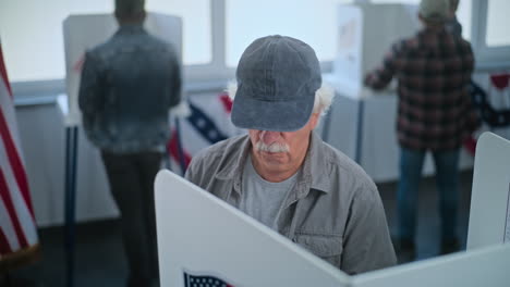 elderly person voting in a polling place