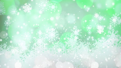 animation of snow falling over snowflakes and light spots on green background at christmas