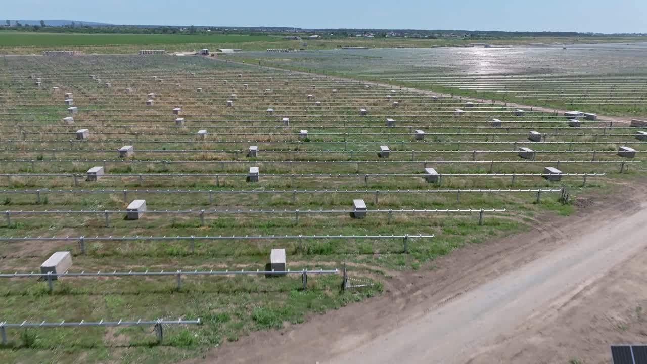 Solar panels in a large field capture sunlight for renewable energy