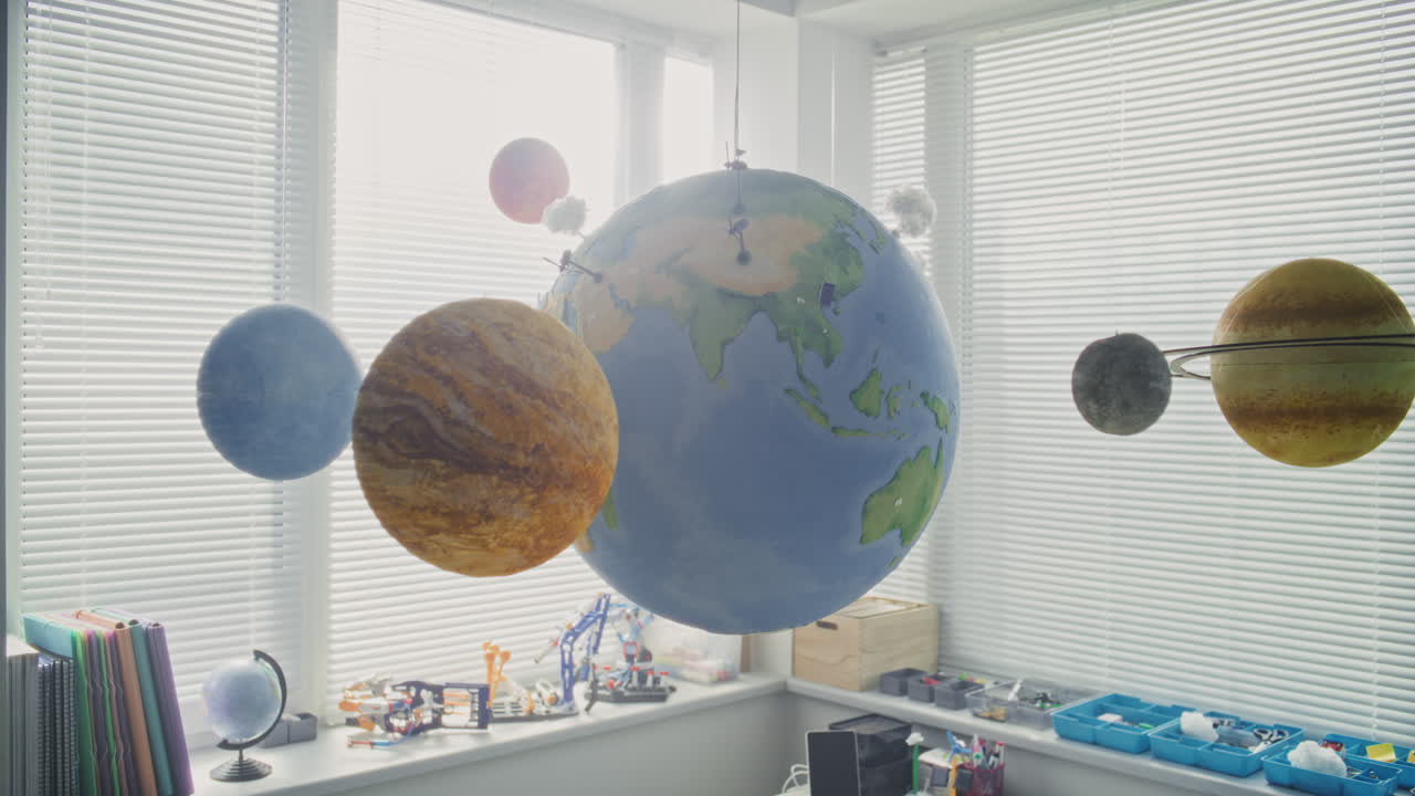 Modern Classroom Close Up of Hanging Models of Solar System and Planets for Studying Astronomy