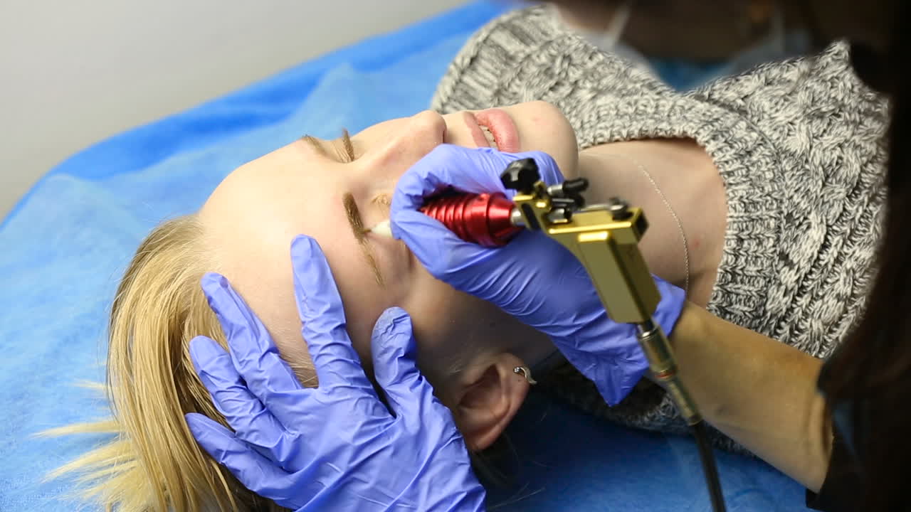 Attractive lady getting facial care and eyebrow tattoo