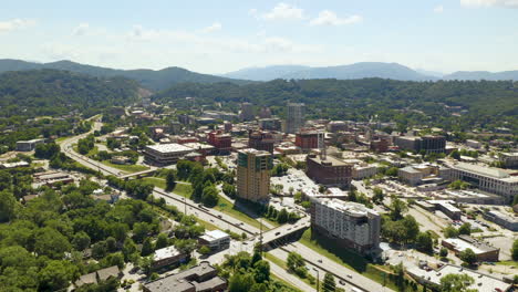 drone pull back over downtown asheville with mountains in the background