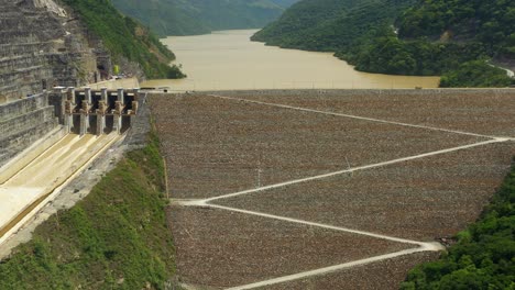 camera flies backwards revealing the flood gates of the hidroituango dam located in ituango, antioquia, in colombia