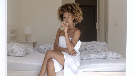 Girl-Drinking-Fresh-Water-On-The-Bed