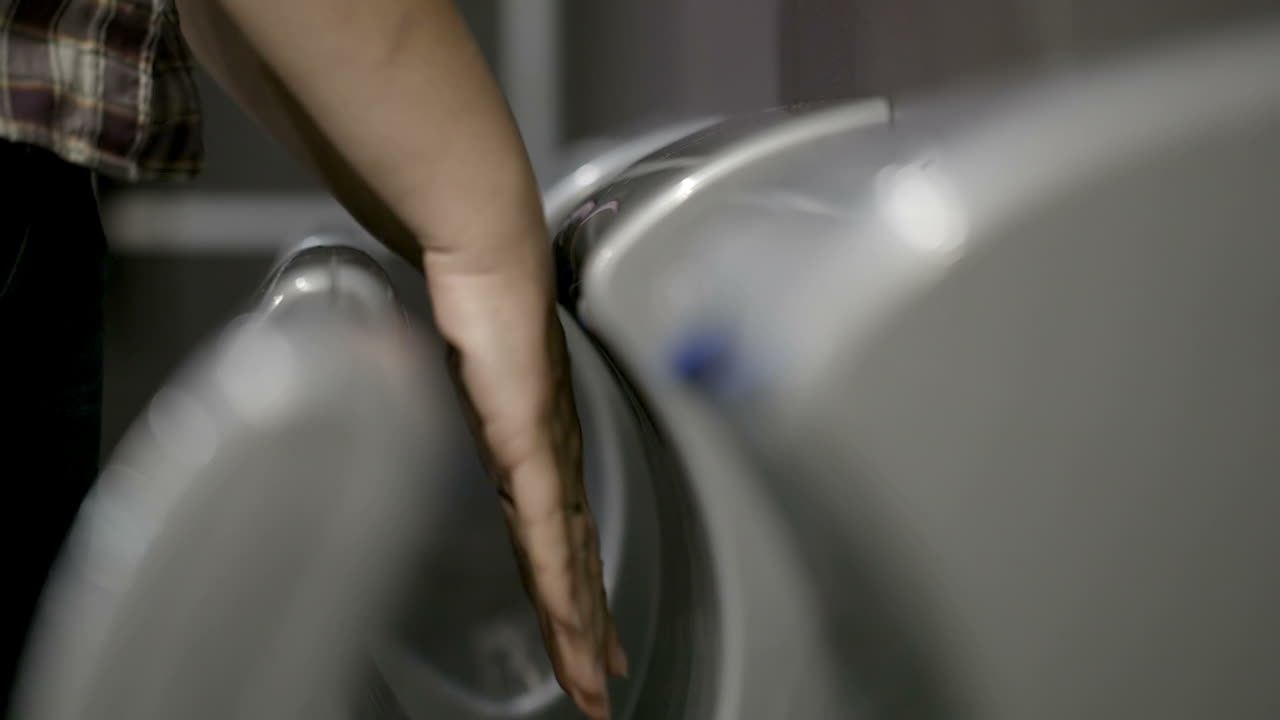 Woman drying hands in special machine