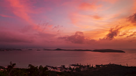 Stunning-colorful-sunrise-over-Noumea-City-from-Ouen-Toro-Point-hilltop-on-the-Grande-Terre,-New-Caledonia---time-lapse