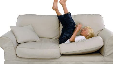 young boy jumping on the sofa on white background