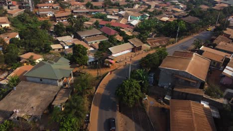 Aerial-view-following-a-truck-carrying-red-sand-on-the-streets-of-suburban-Yaounde,-Cameroon