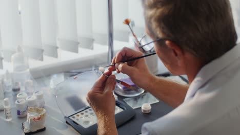 dental technician working on a prosthetic tooth