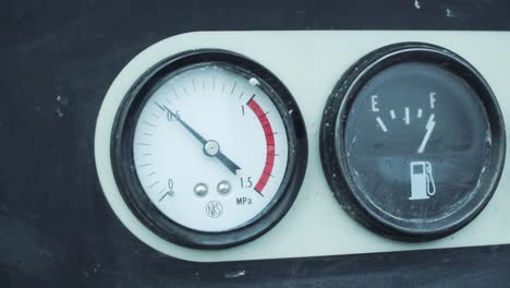 machine instrument panel with pressure and fuel gauges