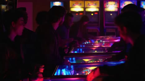 friends playing pinball in a retro arcade