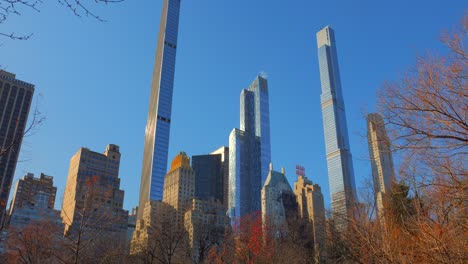 skyscrapers under blue sky view from central park in new york city, usa