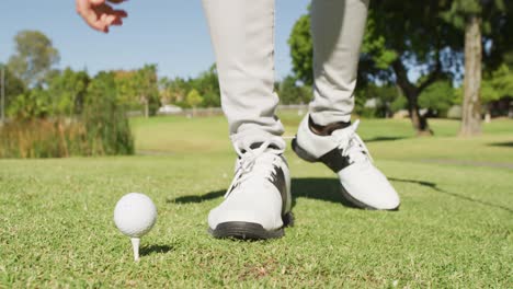 video of hands and legs of caucasian man playing golf on golf field