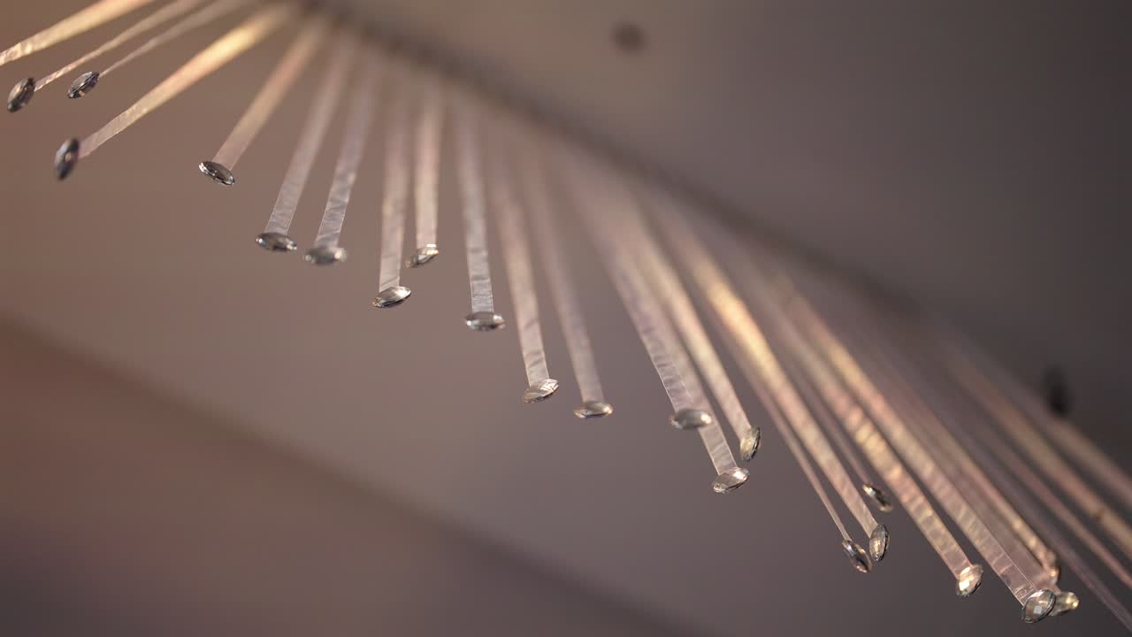 Looking up of closer hanging metallic wedding rods decoration by soft warm lights environment