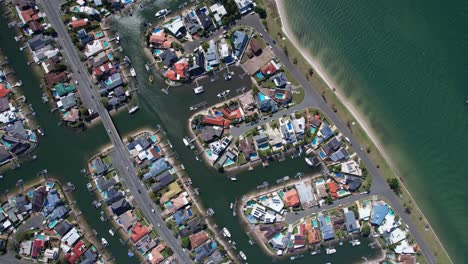 bird's eye view over sovereign islands in paradise point, gold coast, queensland, australia - drone shot