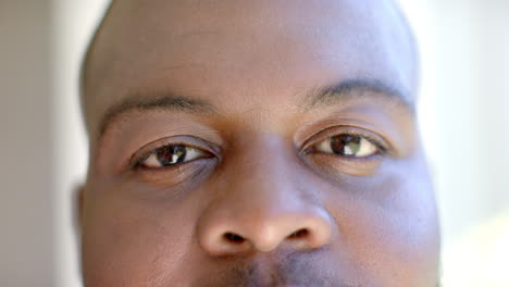 close-up of man's face with focused eyes, looking directly at camera