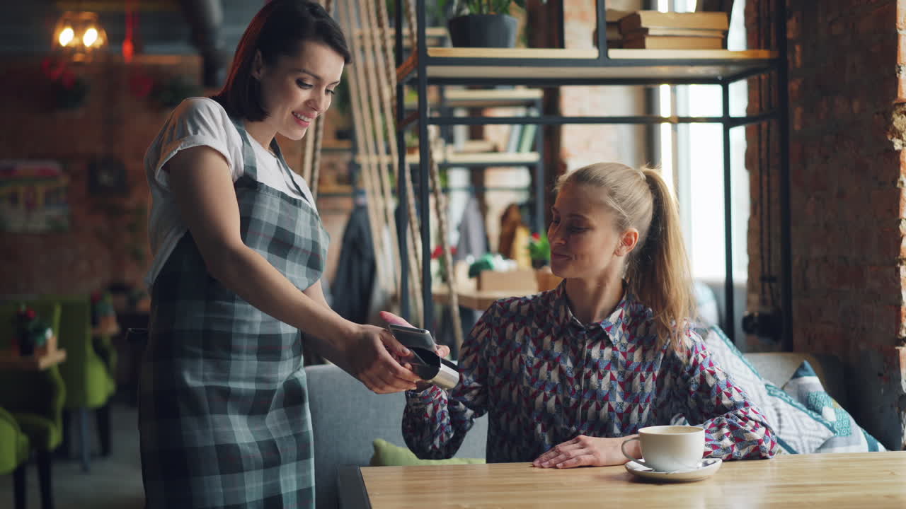 Woman waitress serving customer in a cafe