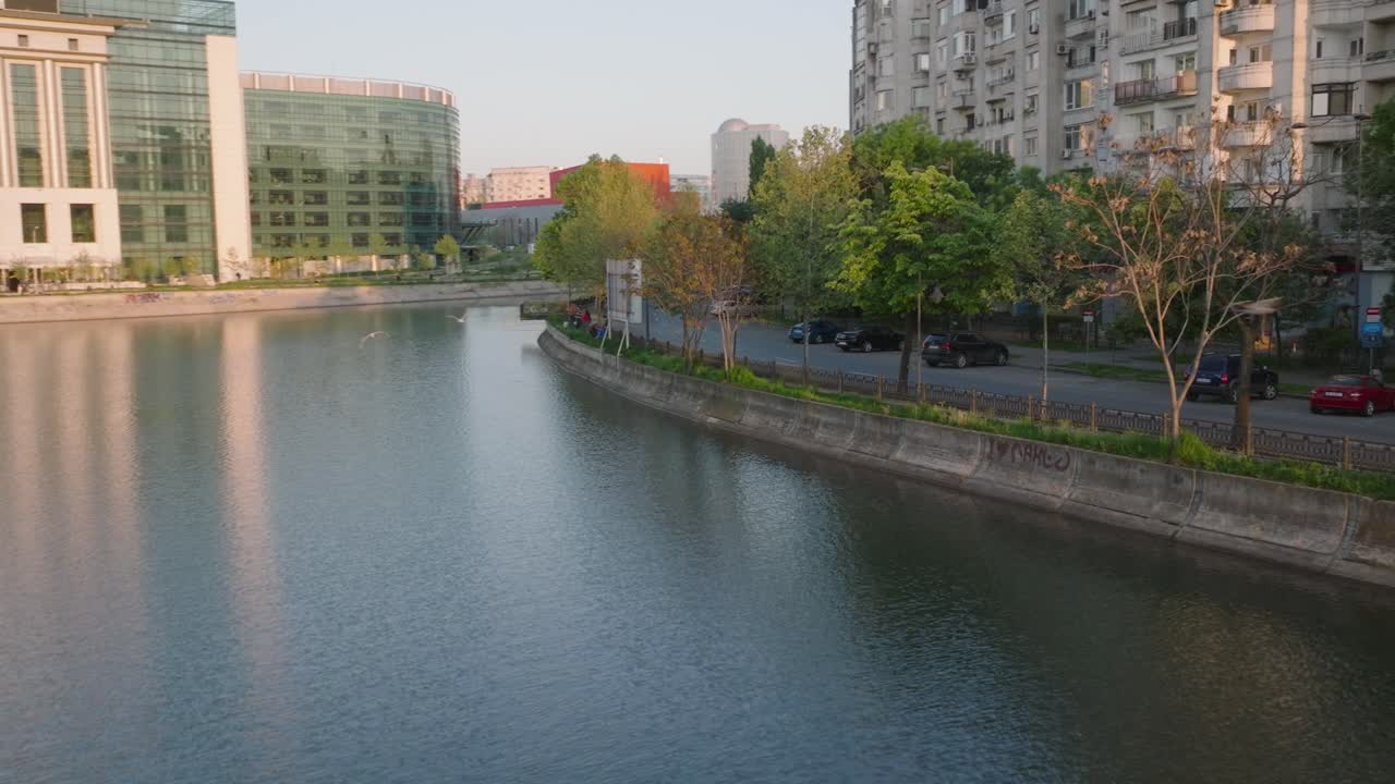 Aerial flight over river with famous palace of parliament in Bucharest city