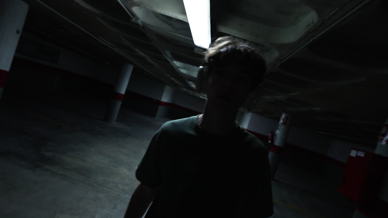 Teenager in a Dark Underground Parking Garage