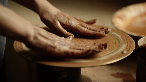 Closeup-woman-hands-having-rest-in-pottery.-Girl-putting-hands-on-potters-wheel