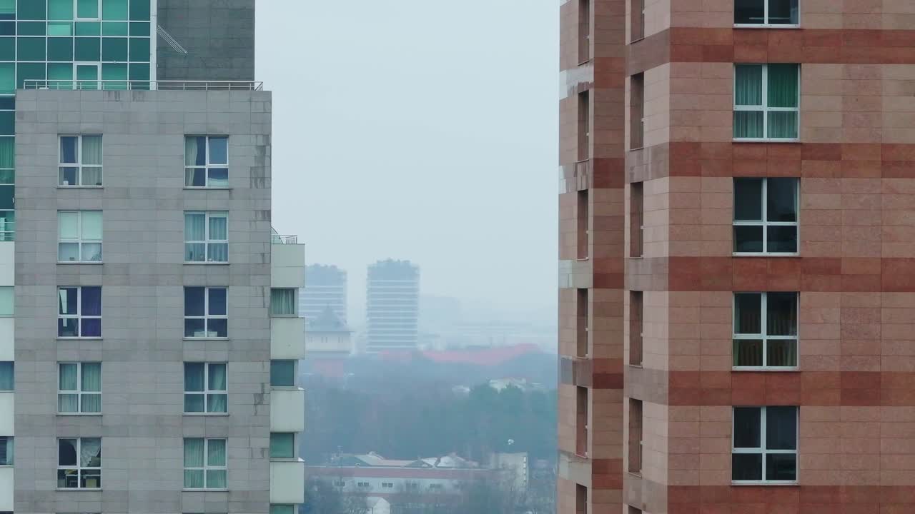 Riga’s urban landscape, modern skyscrapers and distant high-rises on cloudy day