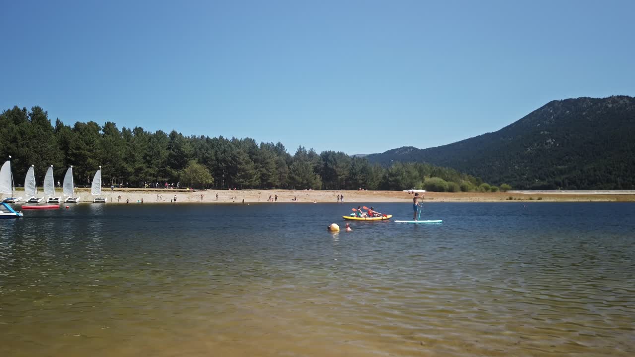 People paddleboarding on Lake Matemale in the French Pyrenees