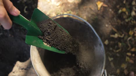 close-up of gardner using trowel